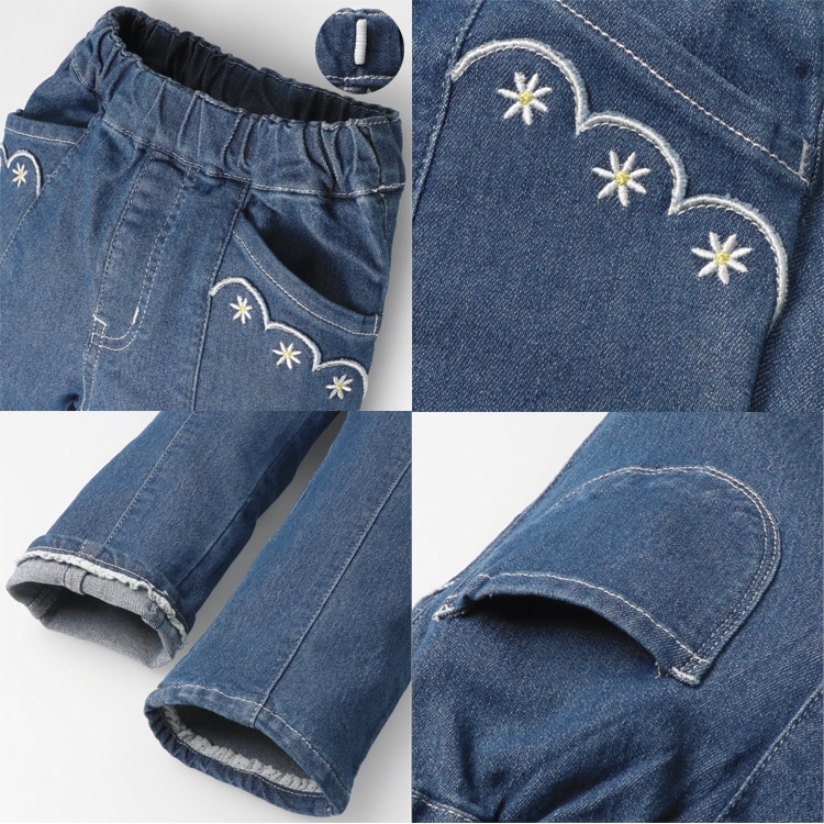 Stretch denim pants with ribbon and flower embroidery at hem